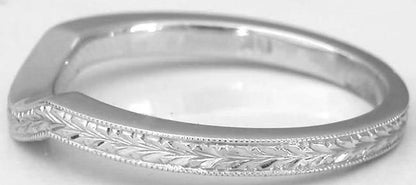 A white gold ring with an engraved leaf pattern along the band, shown on a plain light background.