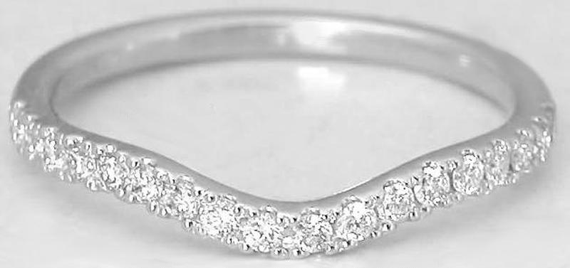 A white gold wavy band ring set with a row of clear round-cut diamonds along the front curve, photographed on a plain light background.