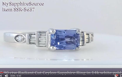 A video link featuring a radiant-cut blue sapphire center stone with baguette and round side stones, shown on a plain light background. Text overlays identify the item as a Ceylon Sapphire ring in 14k white gold.