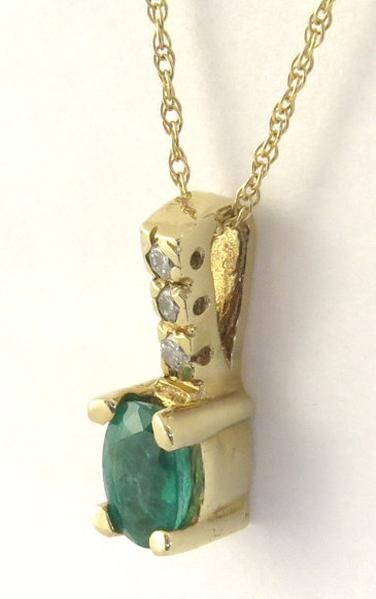 Natural oval emerald solitaire pendant with diamond bail in 14k yellow gold