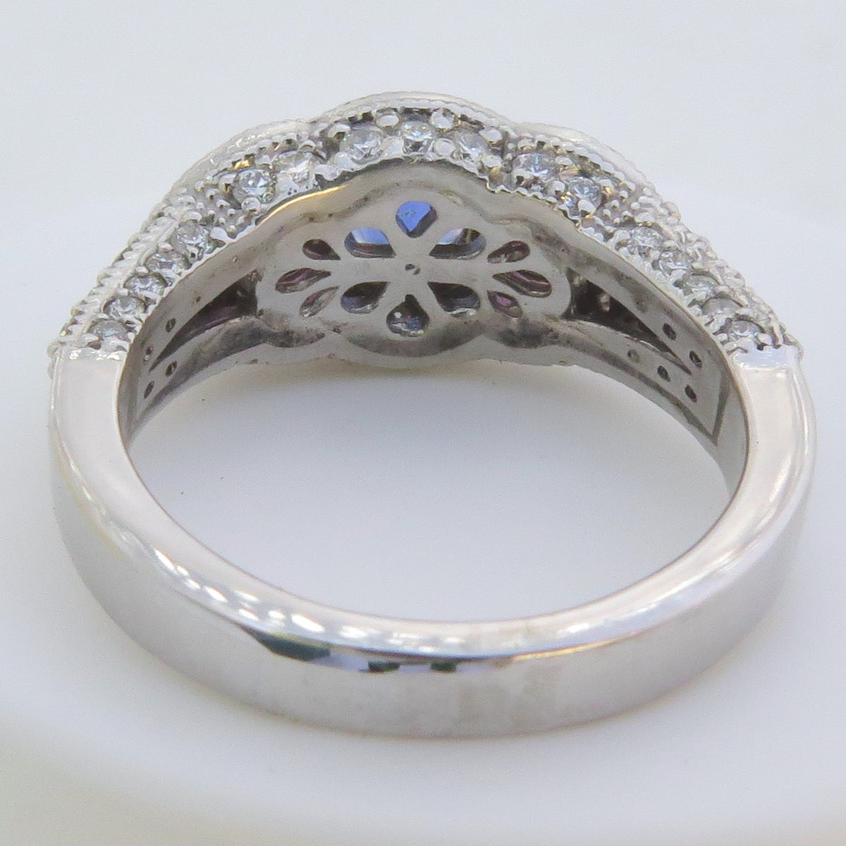 back view showing floral gallery of sapphire ring