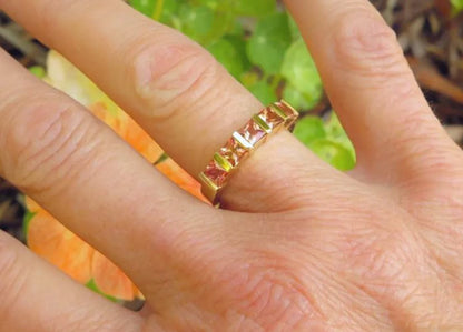natural sapphire bar-set ring featuring peach orange and pink princess cuts