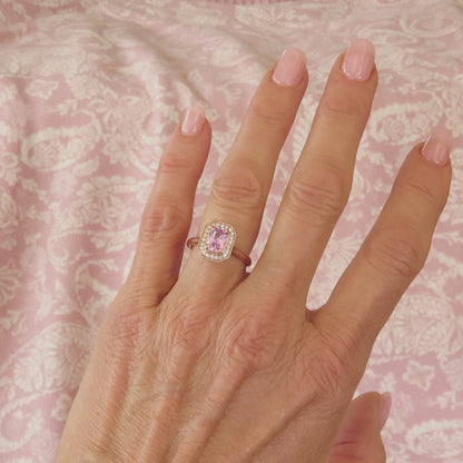 light pink radiant cut sapphire in a diamond halo vintage setting in rose gold on the finger