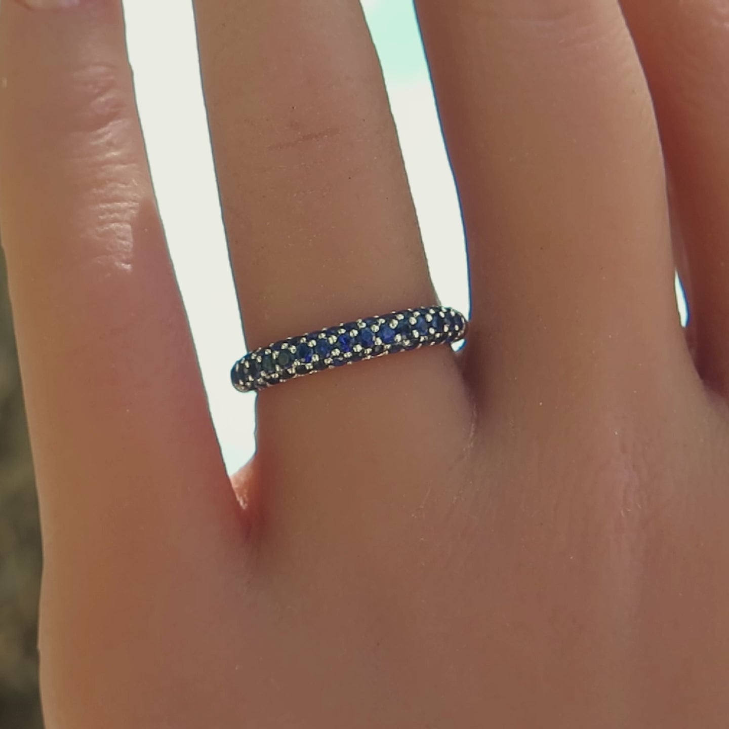 three row pave blue sapphire ring in white gold on the hand