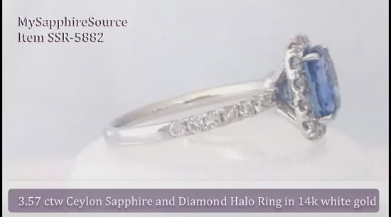 Intsense cornflower blue oval Natural Sapphire in an eye-catching diamond halo mounting (SSR-5882)