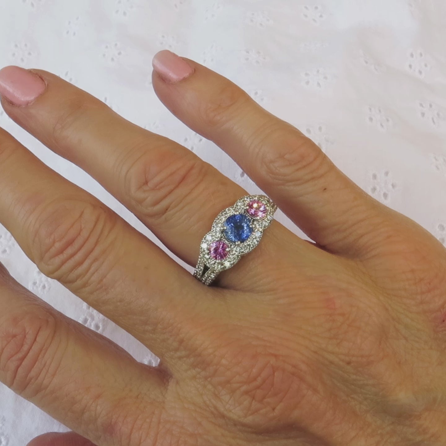 diamond encrusted sapphire and pink sapphire diamond ring in 14k white gold on the hand