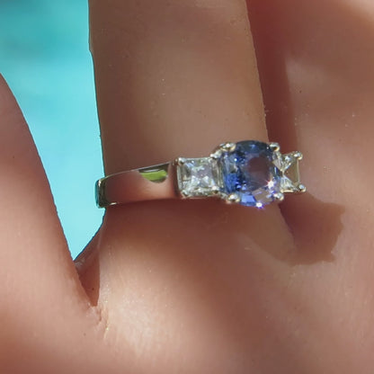 3 stone blue and white sapphire ring in white gold on the finger