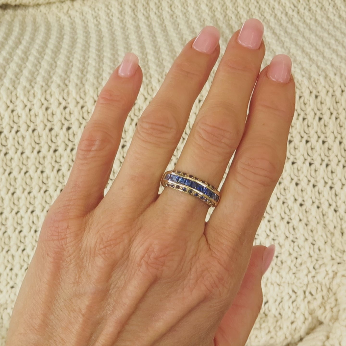 ombre princess and round cut blue sapphires channel and pave set in yellow gold shown on the finger