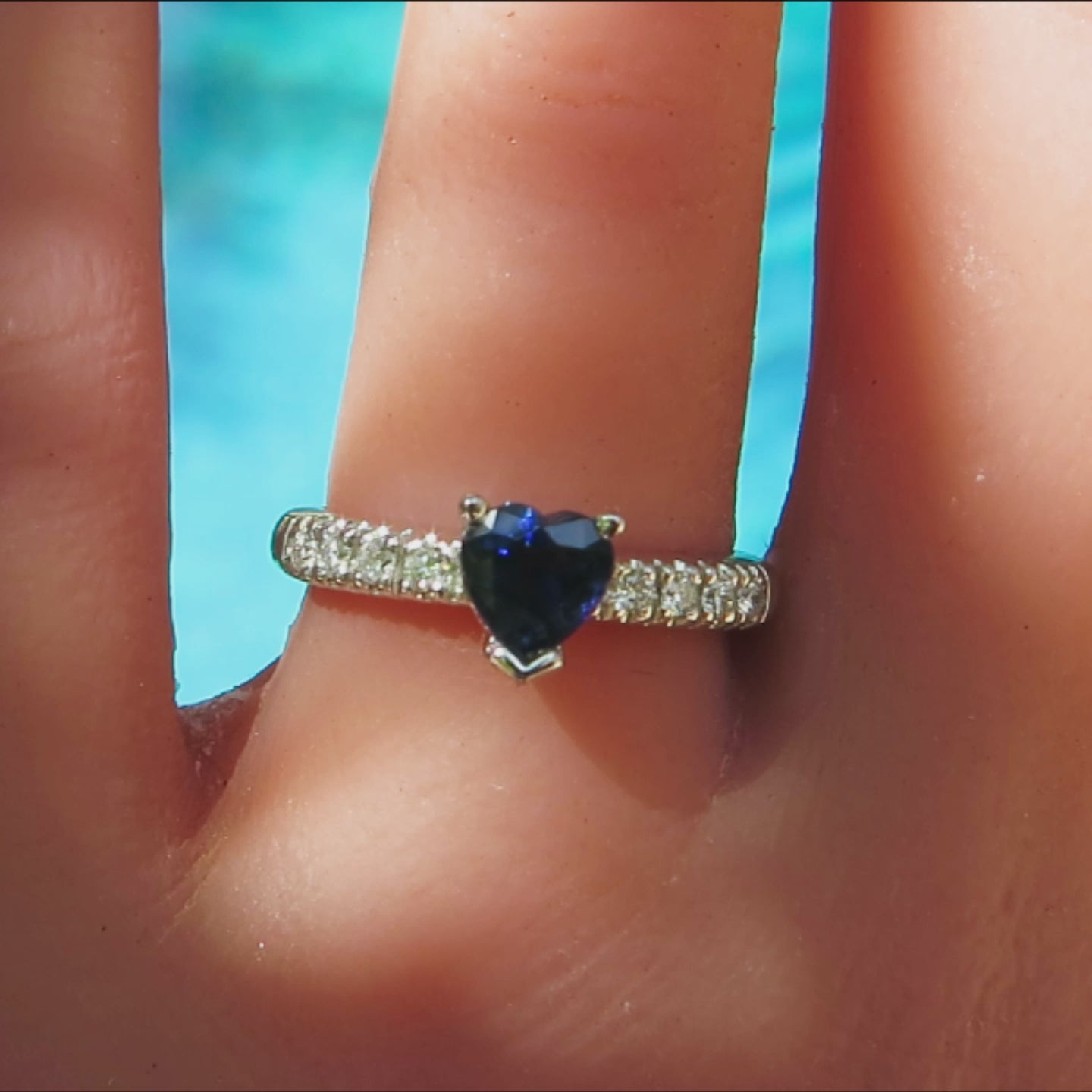heart cut blue sapphire diamond ring in 14k white gold shown on the finger