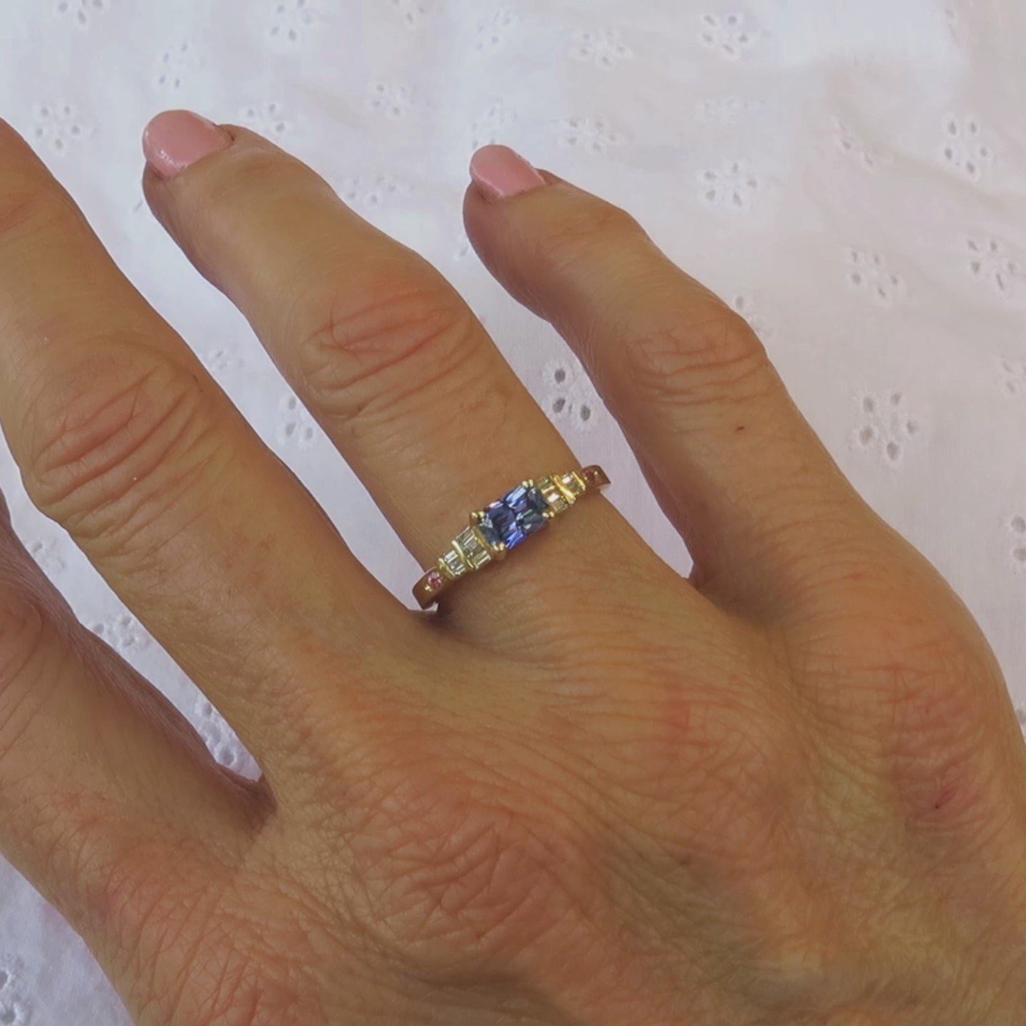 delicate light blue sapphire ring shown on a ladies' hand