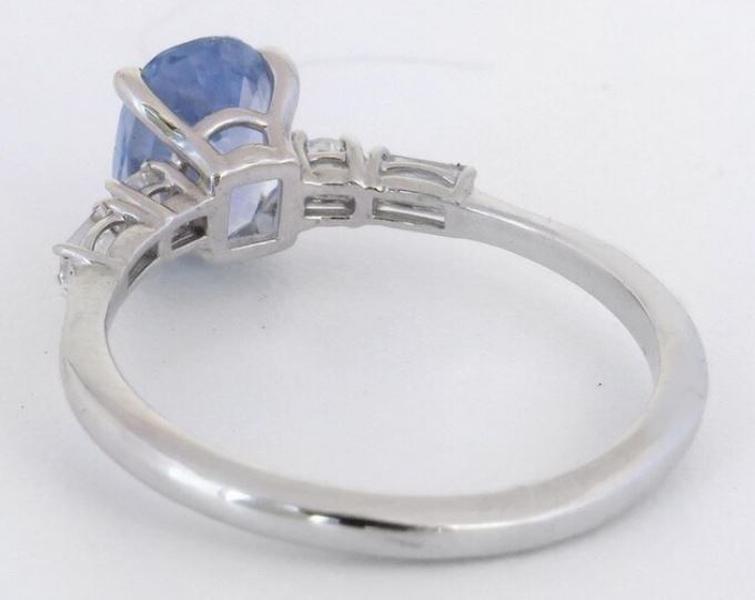 Cornflower blue sapphire ring with baguette and round diamond accents back view