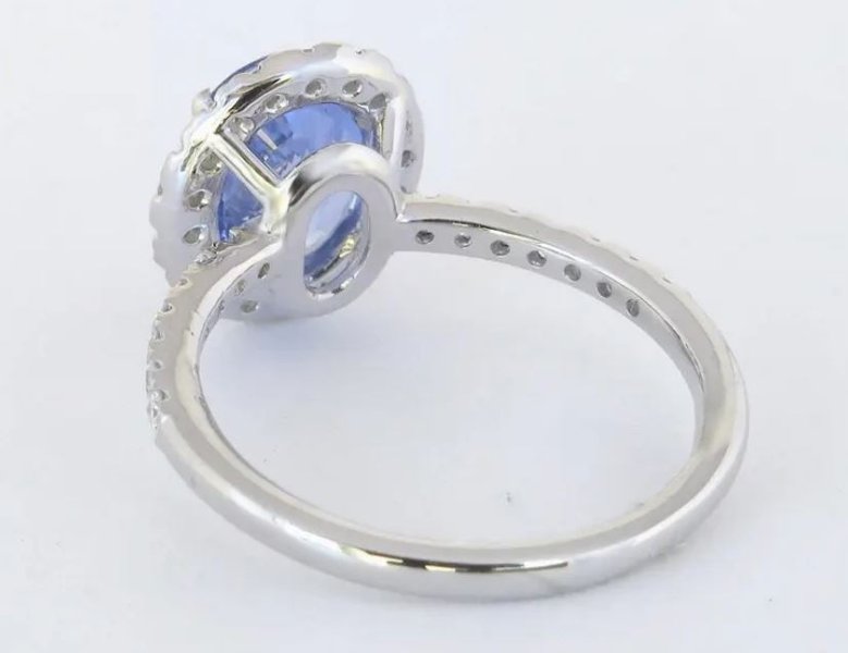 Cornflower blue sapphire halo ring with diamond accents in white gold