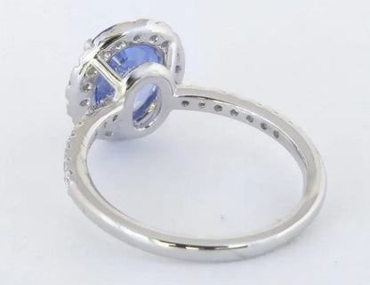 Cornflower blue sapphire halo ring with diamond accents in white gold
