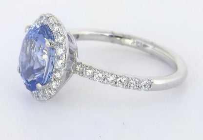 Cornflower blue Ceylon sapphire and diamond halo ring in white gold