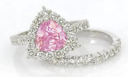 Natural trillion cut pink sapphire ring with a diamond halo in 14k white gold shown with it's matching diamond band