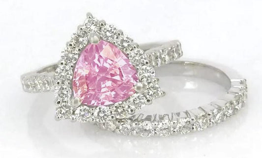 Natural trillion cut pink sapphire ring with a diamond halo in 14k white gold shown with it's matching diamond band