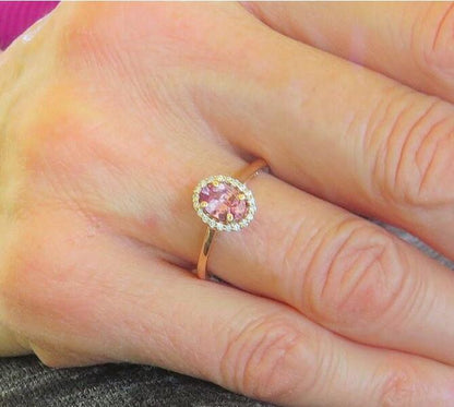 Natural Ceylon rosy pink sapphire ring in 14k rose gold with a diamond halo