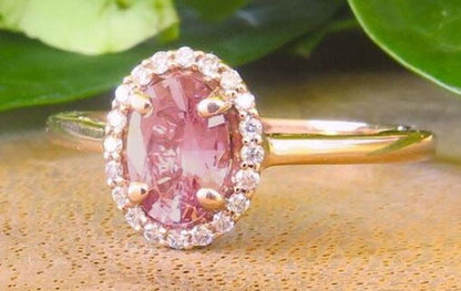Natural Ceylon rosy pink sapphire ring in 14k rose gold with a diamond halo