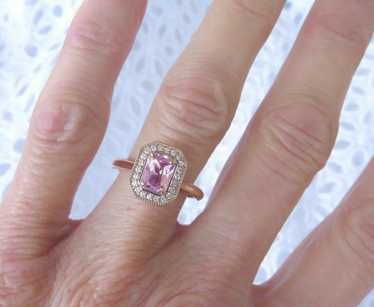 Elegant pink sapphire ring featuring 46 sparkling accent diamonds