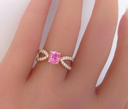 Oval pink sapphire ring in 14k rose gold with diamond split shank