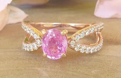 Oval pink sapphire ring in 14k rose gold with diamond split shank