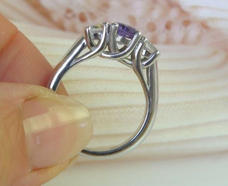 Classic 14k white gold band with purple sapphire centerpiece