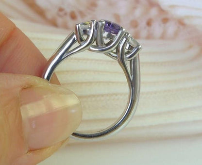 Classic 14k white gold band with purple sapphire centerpiece