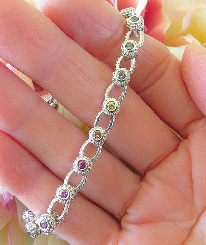 Bezel set round real rainbow sapphire bracelet in solid 14k white gold. 7 inch.