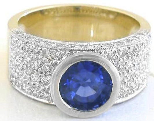 Bezel set round cut natural yellow sapphire ring in 18k white and yellow gold