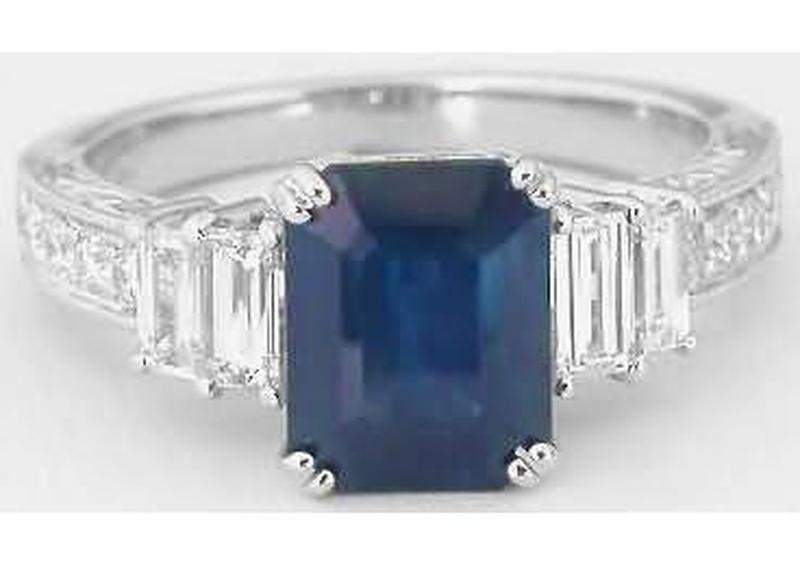 Natural Rich Blue Sapphire in an Emerald Cut Flanked by Pairs of Fine Baguette Diamonds in Vintage Inspired Setting