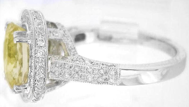 Large Natural oval yellow sapphire diamond halo ring in white gold with milgrain edging