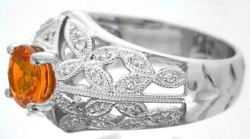 Side View of Floral Design Wide Band Vintage Styled Ring with Milgrain Edging Featuring Orange Sapphire