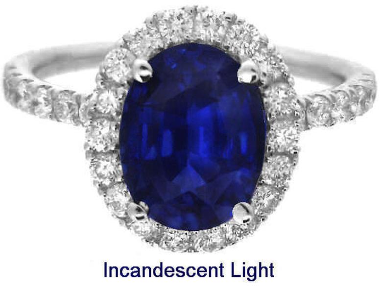 Large halo set oval cut natural blue sapphire engagement ring in 14k white gold