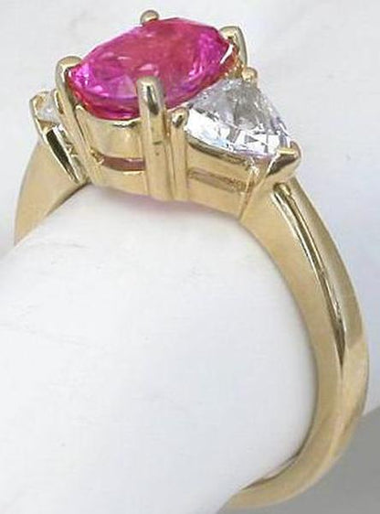 Side View of Three Stone Hot Pink Unheated Sapphire and Trillion White Pink Sapphire Ring in 14k yellow gold