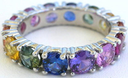 Round cut natural rainbow sapphire eternity ring in gold