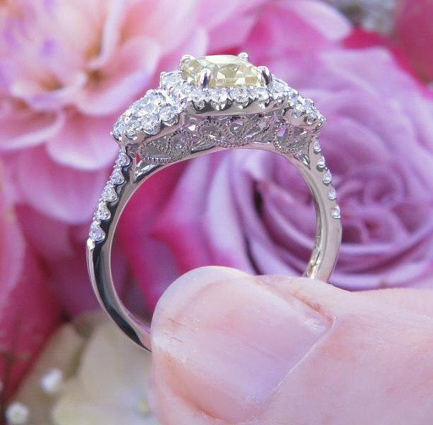 Natural Radiant Yellow Sapphire Three Stone Statement Ring with a Real Diamond Halo in 18k white gold for sale